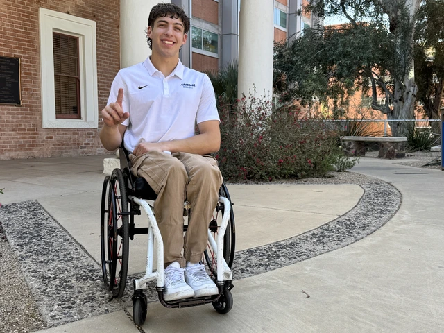 A man in a wheelchair poses for a photo.