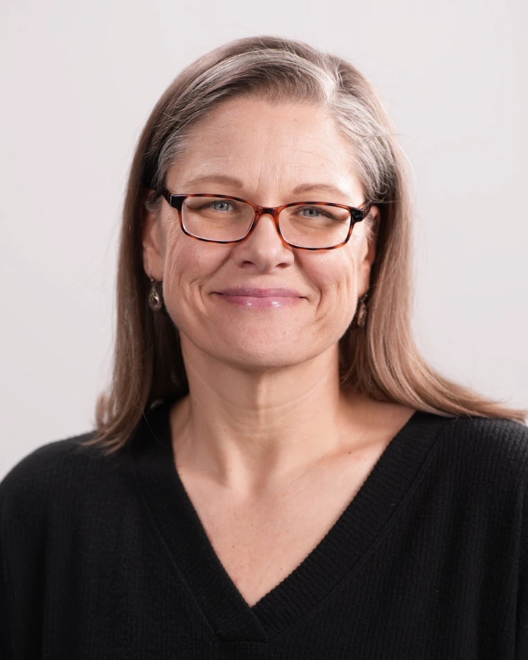 portrait of person with long hair and glasses