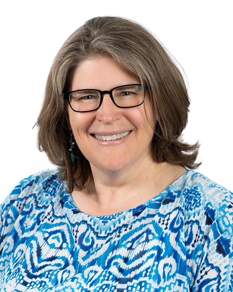 portrait photo of person with dark hair and glasses