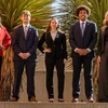 students in suits pose for a photo