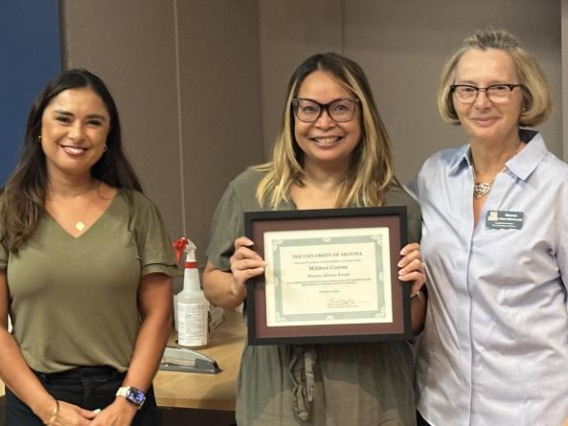 Mildred Curran, center, accepts her Region 10 National Academic Advising Association award.