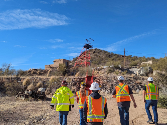 group of people wearing safety vests and helmets