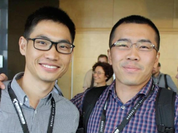 two people, wearing glasses, smiling