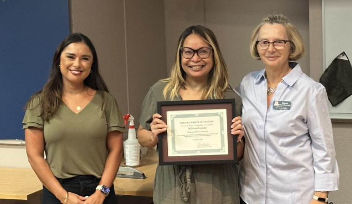 Mildred Curran, center, accepts her Region 10 National Academic Advising Association award.