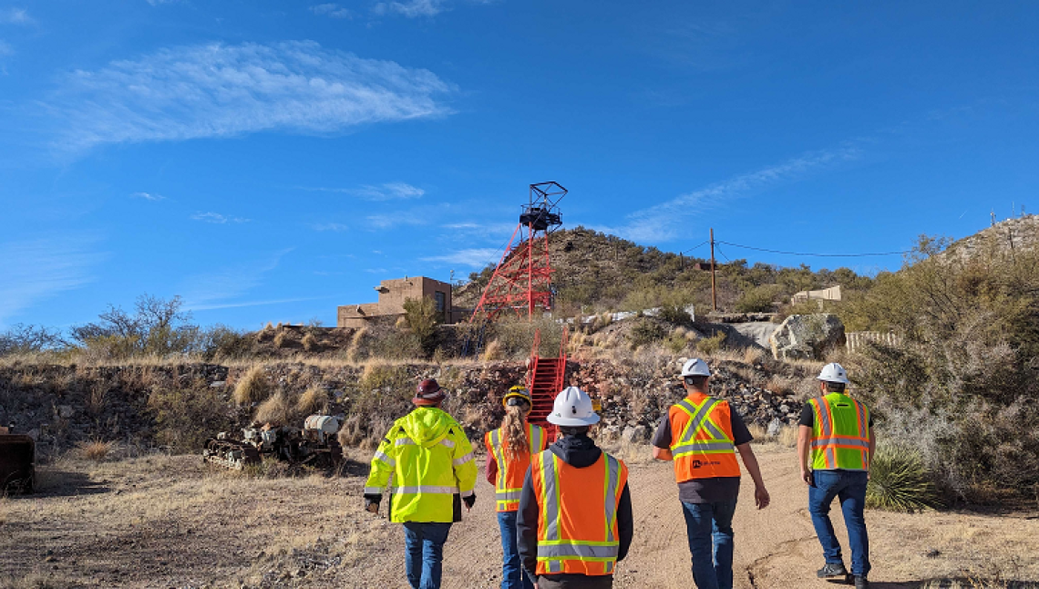 group of people wearing safety vests and helmets