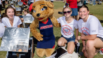 Engineering students pose with Wilma Wildcat at the 2023 Solar Oven Throw Down