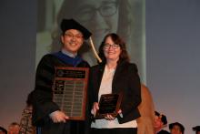 Marla Peterson accepts her SIE Alumni of the Year Award from former department head Young-Jun Son.