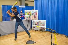 Swing, batter! At the Science of Baseball booth at STEAMworks 2016. Photo courtesy of the UA Office of the Chief Information Officer.