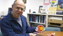 Wolfgang Fink holding a diagram of an eye