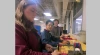 Team 25015 members (from left) Samantha Fisher, Joseph Lee and Will Zupancic adjust the cable tray mounts they designed and produced for making cables easier to manipulate in data centers.