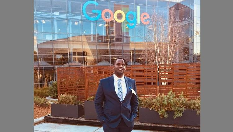 Andrew Kirima in front of a Google building