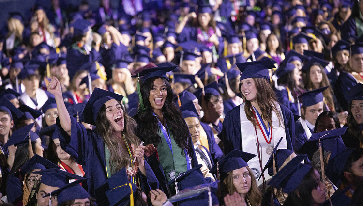 A group of University of Arizona students at graduation in caps and gowns