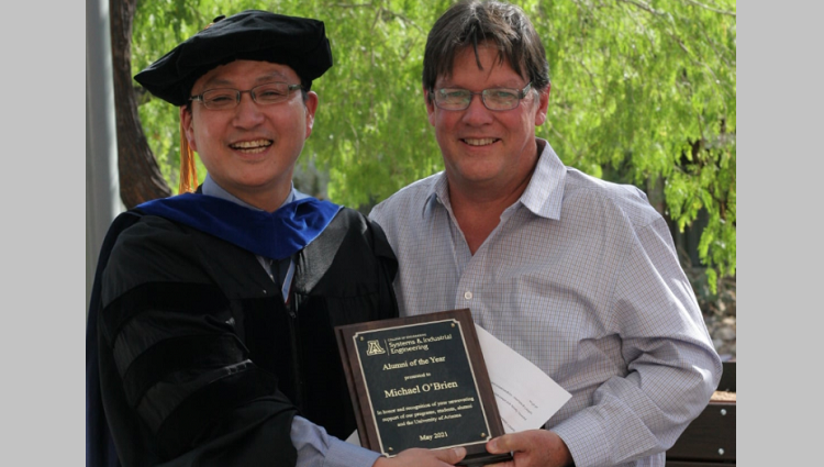 Mike O'Brien accepting his award from SIE department head Young-Jun Son