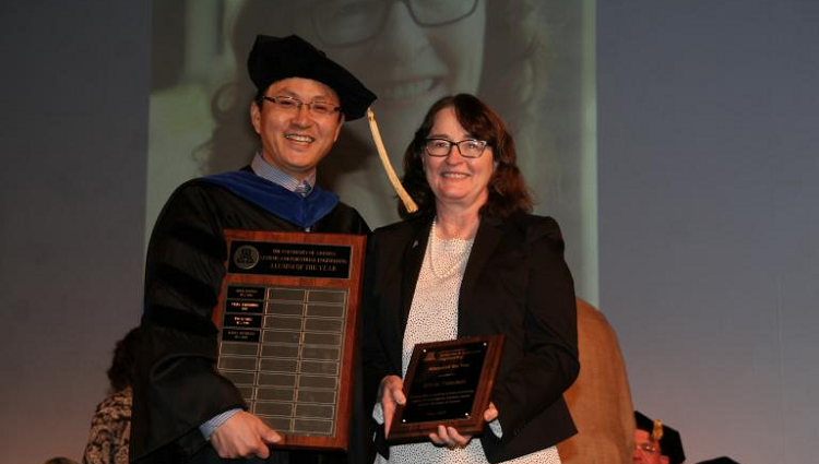 Marla Peterson accepting her SIE Alumni of the Year Award from department Head Young-Jun Son in 2019.