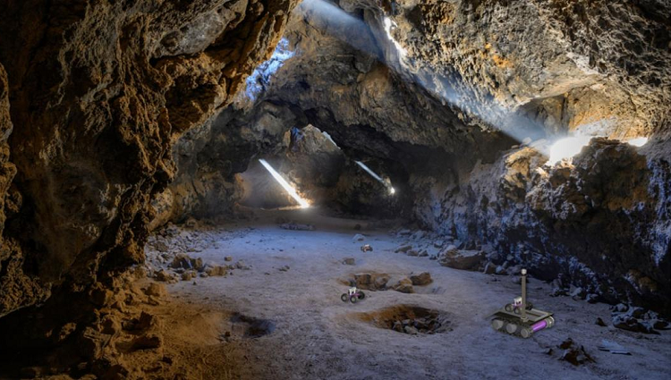 In this artist's impression of the breadcrumb scenario, autonomous rovers can be seen exploring a lava tube. John Fowler/Wikimedia Commons, Mark Tarbell and Wolfgang Fink/University of Arizona
